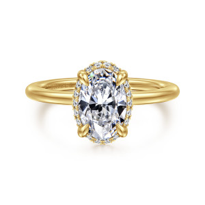 Gabriel & Co. ER16516O6Y44JJ 14 karat yellow gold Classic engagement ring, front view of an oval center with teardrop shaped prongs and a thin edge of small diamonds