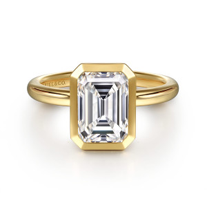 Gabriel & Co. ER16526E8Y4JJJ 14 karat yellow gold Contemporary engagement ring, front view of a smooth bezel with clipped corners surrounding an emerald cut center