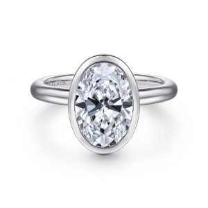 Gabriel & Co. ER16526O8W4JJJ 14 karat white gold Contemporary engagement ring, front view of an oval center wrapped in a smooth bezel rim on a plain rounded band