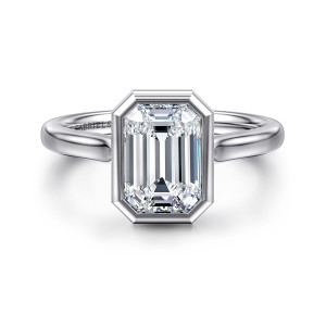Gabriel & Co. ER16527E8W4JJJ 14 karat white gold Contemporary engagement ring, front view of a bezel with clipped corners around an emerald cut center above a plain band