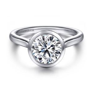 Gabriel & Co. ER16527R8W4JJJ 14 karat white gold Contemporary engagement ring, front view of a smooth round bezel rim around the center with band shoulders rising on both sides