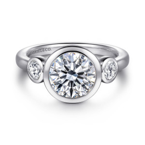 Gabriel & Co. ER16528R8W44JJ 14 karat white gold Contemporary engagement ring, front view of a round center in a wide bezel between two bezel set round diamonds