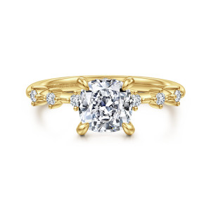 Gabriel & Co. ER16530C6Y44JJ 14 karat yellow gold Starlight engagement ring, front view of a cushion center between small round stones set apart on a thin band