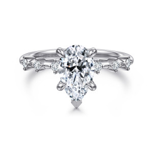 Gabriel & Co. ER16530P6W44JJ 14 karat white gold Starlight engagement ring, front view of a pear shaped center with a V tip at its point and spaced small diamonds