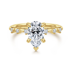 Gabriel & Co. ER16530P6Y44JJ 14 karat yellow gold Starlight engagement ring, front view of a pear shaped center with a V shaped tip prong and spaced diamonds beside it