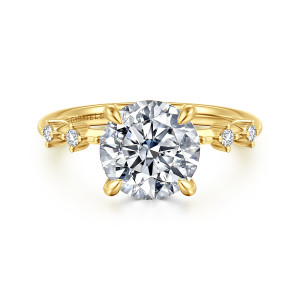 Gabriel & Co. ER16530R10Y44JJ 14 karat yellow gold Starlight engagement ring, front view of a round center with teardrop tipped prongs and spaced diamonds at each shoulder