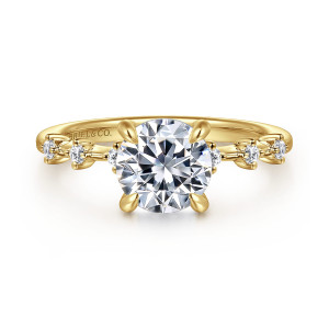 Gabriel & Co. ER16530R6Y44JJ 14 karat yellow gold Starlight engagement ring, front view of a round center in four claws with small diamonds spaced along a thin band