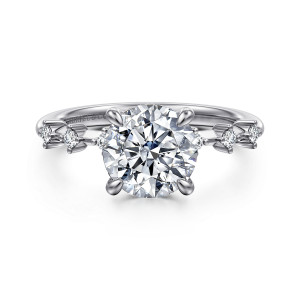 Gabriel & Co. ER16530R8W44JJ 14 karat white gold Starlight engagement ring, front view of a round center with widely spaced small diamonds flanking it on thin shoulders