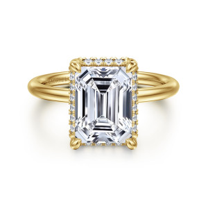 Gabriel & Co. ER16565E12Y44JJ 14 karat yellow gold Contemporary engagement ring, front view of an emerald cut center in corner claws with small stones peeking out at its edge