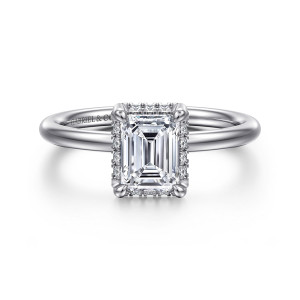 Gabriel & Co. ER16565E4W44JJ 14 karat white gold Contemporary engagement ring, front view of an emerald cut center in four prongs with small stones showing between them