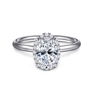 Gabriel & Co. ER16565O6W44JJ 14 karat white gold Contemporary engagement ring, front view of an oval center with four rounded claws and small stones peeking out around its edge
