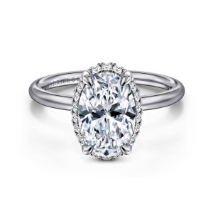 Gabriel & Co. ER16565O8W44JJ 14 karat white gold Contemporary engagement ring, front view of an oval center in rounded tip prongs with small diamonds peeking out around its edge