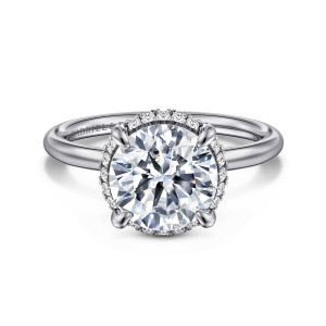 Gabriel & Co. ER16565R10W44JJ 14 karat white gold Contemporary engagement ring, front view of a round center with a thin edge of small diamonds peeking out below the stone
