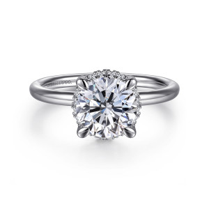 Gabriel & Co. ER16565R6W44JJ 14 karat white gold Contemporary engagement ring, front view of a round center in four rounded prongs with small diamonds glinting at its edge