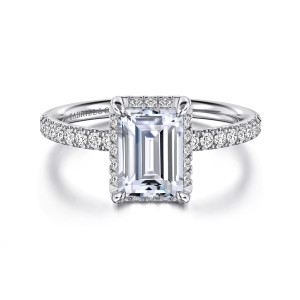 Gabriel & Co. ER16566E6W44JJ 14 karat white gold Contemporary engagement ring, front view of an emerald cut center with corner prongs and a hidden halo peeking out
