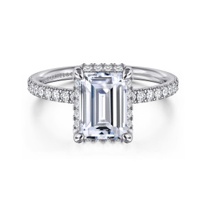 Gabriel & Co. ER16566E8W44JJ 14 karat white gold Contemporary engagement ring, front view of an emerald cut center with rounded corner prongs and diamonds along the shoulders