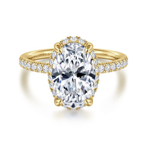 Gabriel & Co. ER16566O12Y44JJ 14 karat yellow gold Contemporary engagement ring, front view of a hidden halo edging the oval center between four bulb tipped prongs
