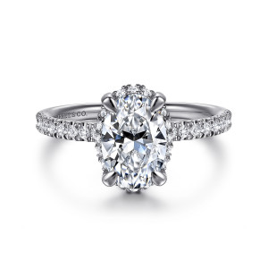 Gabriel & Co. ER16566O6W44JJ 14 karat white gold Contemporary engagement ring, front view of an oval center with four claws and tiny stones peeking at its edges