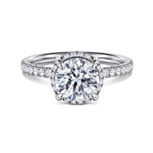 Gabriel & Co. ER16566R6W44JJ 14 karat white gold Contemporary engagement ring, front view of a round seat with small stones peeking between the prongs and diamonds on the band