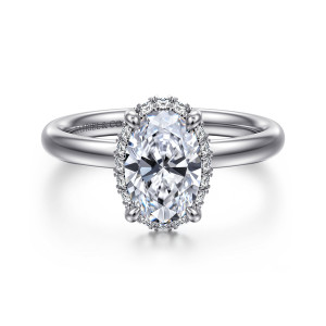 Gabriel & Co. ER16567O6W44JJ 14 karat white gold Contemporary engagement ring, front view of an oval center framed by a thin rim of halo diamonds and four rounded prongs