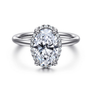 Gabriel & Co. ER16567O8W44JJ 14 karat white gold Contemporary engagement ring, front view of a smooth rounded band and an oval center edged with tiny halo stones
