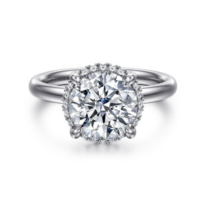 Gabriel & Co. ER16567R10W44JJ 14 karat white gold Contemporary engagement ring, front view of a round center in thick claws with diamonds peeking around its edge