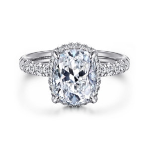 Gabriel & Co. ER16568G12W44JJ 14 karat white gold Contemporary engagement ring, front view of an elongated cushion center with small diamonds hugging its edge and shoulders