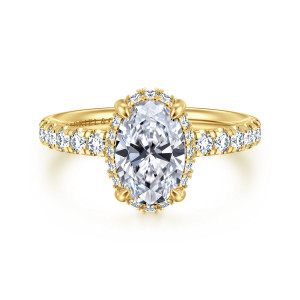 Gabriel & Co. ER16568O6Y44JJ 14 karat yellow gold Contemporary engagement ring, front view of the oval center with a fine halo edge and larger diamonds on the shoulders