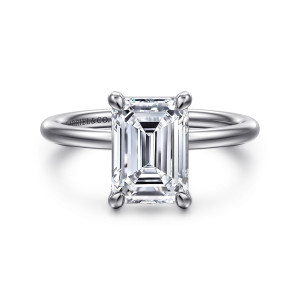 Gabriel & Co. ER16569E10W4JJJ 14 karat white gold Contemporary engagement ring, front view of an emerald cut center in four rounded claw prongs on a slim plain band