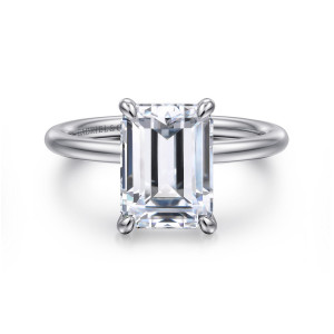 Gabriel & Co. ER16569E12W4JJJ 14 karat white gold Contemporary engagement ring, front view of an emerald cut center at the top of a thin band with rounded corner prongs