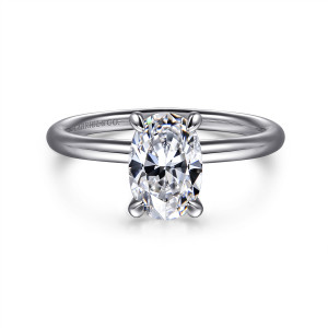 Gabriel & Co. ER16569O4W4JJJ 14 karat white gold Contemporary engagement ring, front view of an oval center gripped by claw prongs with softly rounded tips on a slender band