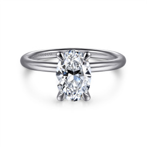 Gabriel & Co. ER16569O6W4JJJ 14 karat white gold Contemporary engagement ring, front view of an oval center held by four slim claws on a thin plain band