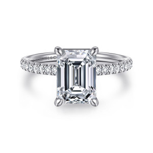 Gabriel & Co. ER16570E10W44JJ 14 karat white gold Contemporary engagement ring, front view of an emerald cut center in claw prongs above a slim band of small stones