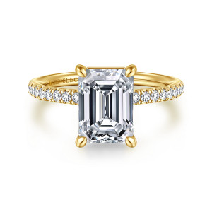 Gabriel & Co. ER16570E10Y44JJ 14 karat yellow gold Contemporary engagement ring, front view of an emerald cut center held by four rounded prongs above a slim pave band