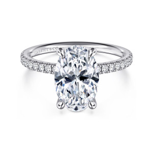 Gabriel & Co. ER16570O12W44JJ 14 karat white gold Contemporary engagement ring, front view of the oval center in rounded prongs with diamonds along both shoulders