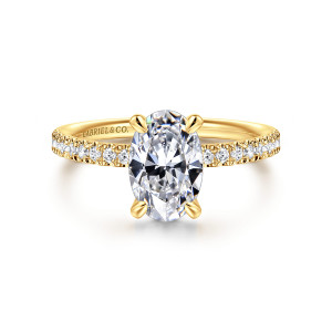 Gabriel & Co. ER16570O6Y84JJ 18 karat yellow gold Contemporary engagement ring, front view of an oval center in four rounded claw prongs above diamonds along the shoulders