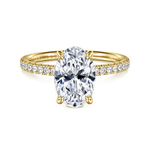 Gabriel & Co. ER16570O8Y44JJ 14 karat yellow gold Contemporary engagement ring, front view of an oval center held by four teardrop tipped prongs above shoulders of small diamonds