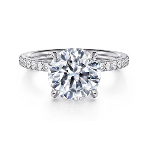 Gabriel & Co. ER16570R12W44JJ 14 karat white gold Contemporary engagement ring, front view of a round center between four prongs with small stones beside it