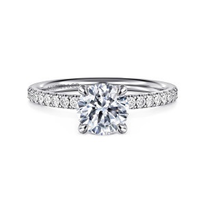Gabriel & Co. ER16570R4W44JJ 14 karat white gold Contemporary engagement ring, front view of the round center on slender prongs with diamonds beside it