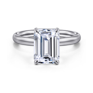 Gabriel & Co. ER16571E12W4JJJ 14 karat white gold Contemporary engagement ring, front view of an emerald cut center in four rounded claw prongs on a smooth domed band