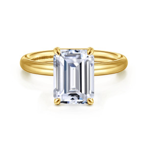 Gabriel & Co. ER16571E12Y4JJJ 14 karat yellow gold Contemporary engagement ring, front view of an emerald cut center in four small tipped prongs on a smooth rounded band