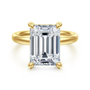Gabriel & Co. ER16571E20Y4JJJ 14 karat yellow gold Contemporary engagement ring, front view of an emerald cut center held at its corners by four prongs above a plain band