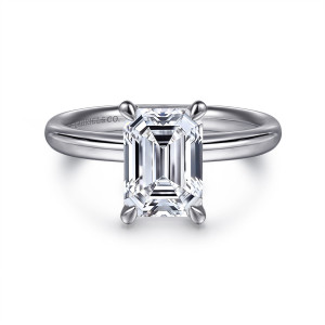 Gabriel & Co. ER16571E8W4JJJ 14 karat white gold Contemporary engagement ring, front view of an emerald cut center in corner claws over a smooth, rounded band with no stones