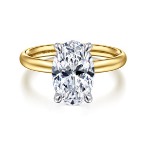 Gabriel & Co. ER16571O12M4JJJ 14 karat white and yellow gold Contemporary engagement ring, front view of an oval center in four cool toned claws on a plain warm toned domed band
