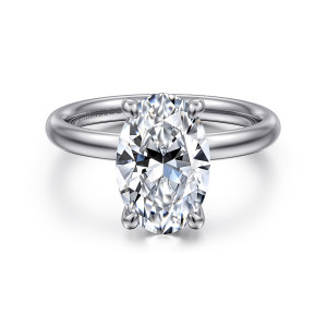 Gabriel & Co. ER16571O12W4JJJ 14 karat white gold Contemporary engagement ring, front view of the oval center between four claw prongs on a smooth rounded band