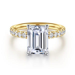 Gabriel & Co. ER16572E12M44JJ 14 karat white and yellow gold Contemporary engagement ring, front view of an emerald cut center in four corner claws over a band of small round diamonds
