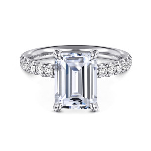Gabriel & Co. ER16572E12W44JJ 14 karat white gold Contemporary engagement ring, front view of an emerald cut center in four corner claws with round diamonds along the shoulders
