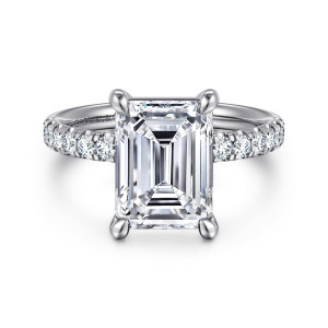 Gabriel & Co. ER16572E16W44JJ 14 karat white gold Contemporary engagement ring, front view of an emerald cut center with rounded corner prongs above diamonds on both shoulders