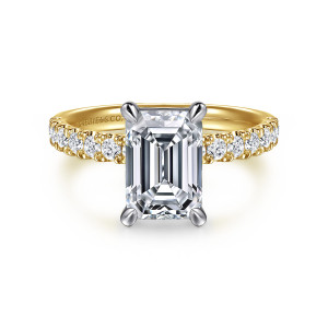 Gabriel & Co. ER16572E8M44JJ 14 karat white and yellow gold Contemporary engagement ring, front view of an emerald cut center in four tapered prongs with round stones on both shoulders