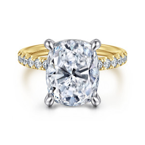 Gabriel & Co. ER16572G20M44JJ 14 karat white and yellow gold Contemporary engagement ring, front view of an elongated cushion center held by four prongs of a different tone than the band